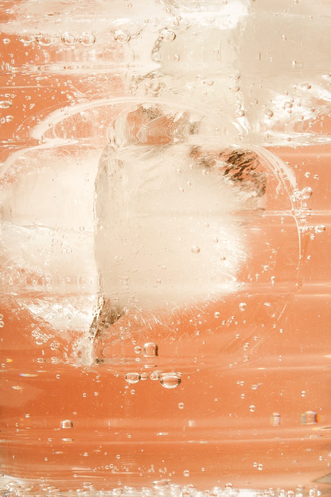 ice and bubbles in a glass of elixir and tonic